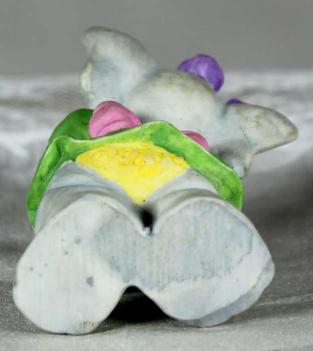 Miniature elephant playing a harmonica