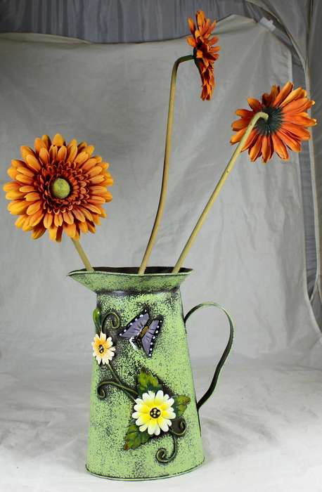Metal pitcher with flowers