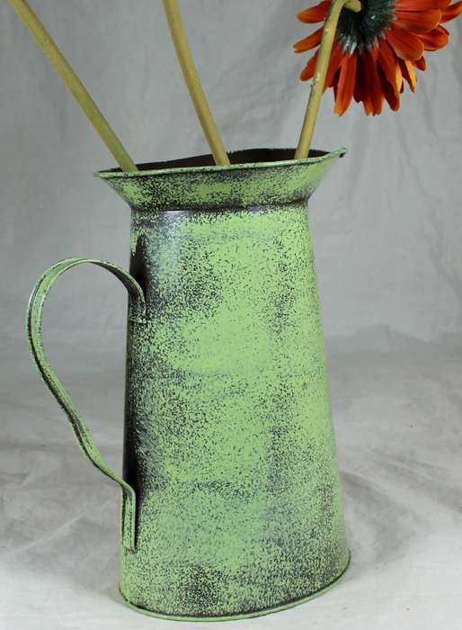 Metal pitcher with flowers