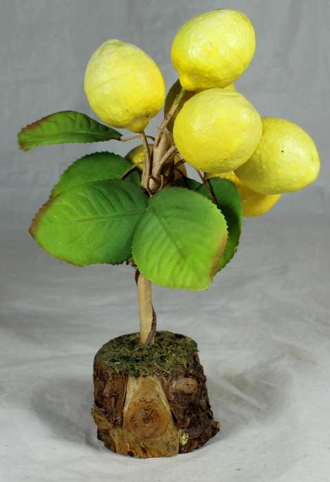 Plastic lemon tree on a wooden base