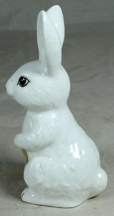 Porcelain bunny holding a paper basket