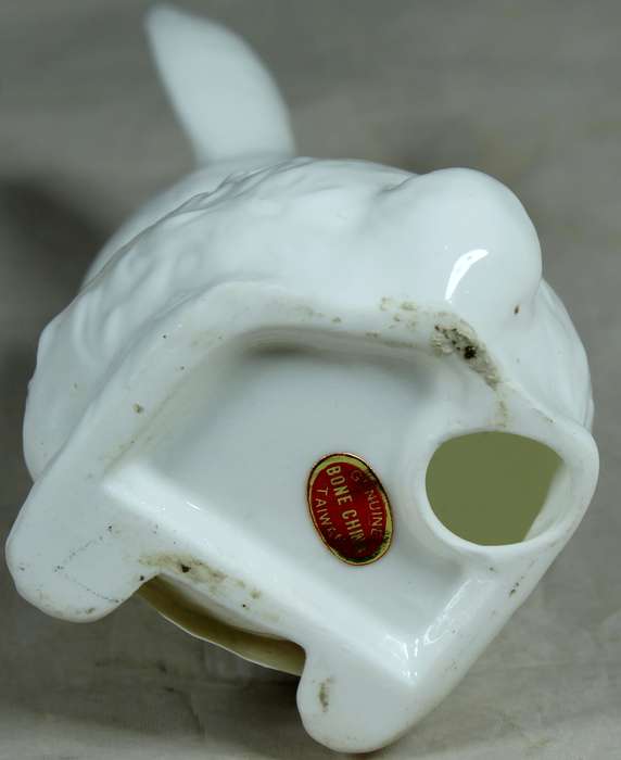 Porcelain bunny holding a paper basket