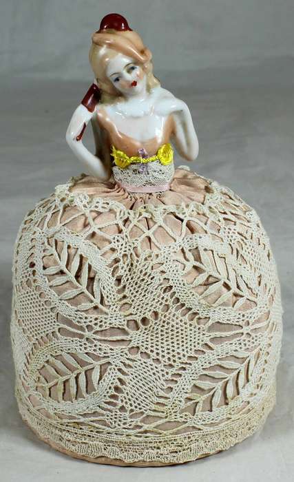 Vintage half-doll with dress and pin cushion -Combing hair