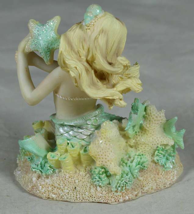Resin mermaid holding a starfish