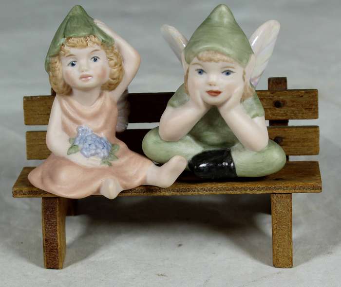 Ceramic pixie angels on a wooden bench