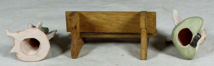 Ceramic pixie angels on a wooden bench