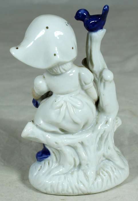 Ceramic girl sitting on a tree stump