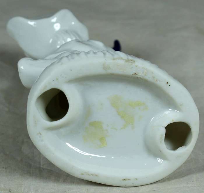 Ceramic girl sitting on a tree stump