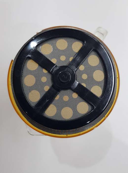 Glass coffee plunger with plastic lid and solid glass handle.