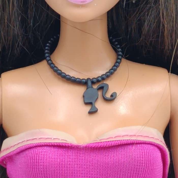 Barbie with pink dress, shoes and necklace