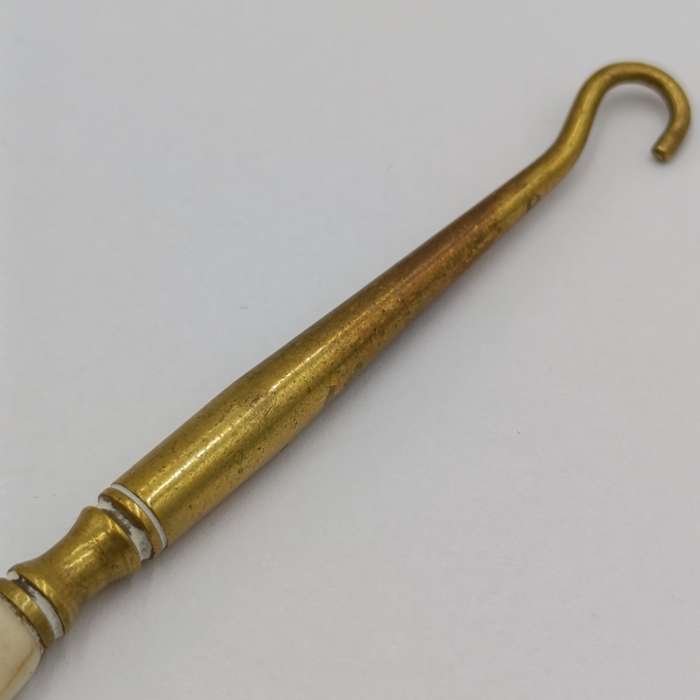 Antique brass bootlace puller with bone handle
