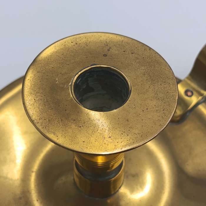 Antique brass candle holder - inscribed at bottom