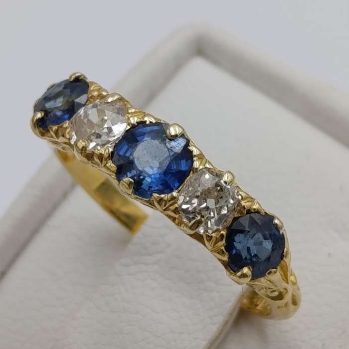 18kt gold ring with 2 diamonds totalling about 40 points and 3 sapphires totalling about 80 points