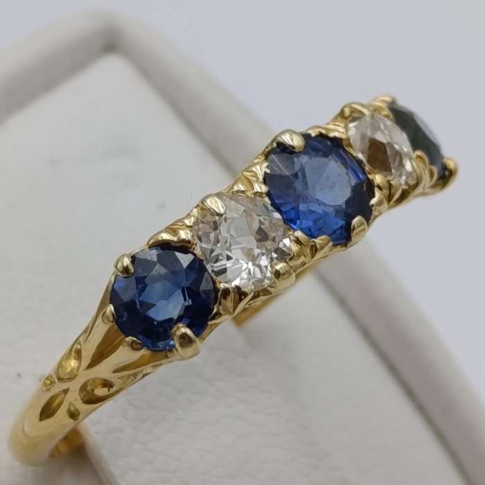 18kt gold ring with 2 diamonds totalling about 40 points and 3 sapphires totalling about 80 points