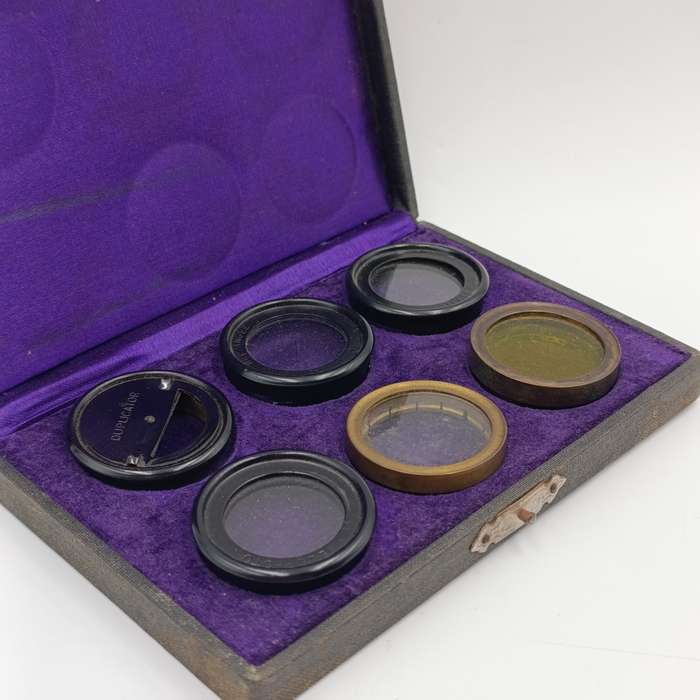 Antique camera lens filter set in case