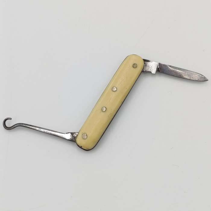Vintage miniature pocket knife with bootlace puller