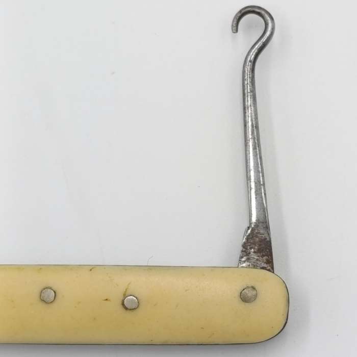 Vintage miniature pocket knife with bootlace puller