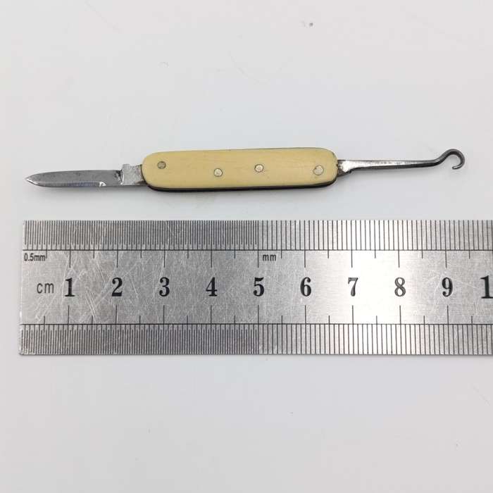 Vintage miniature pocket knife with bootlace puller