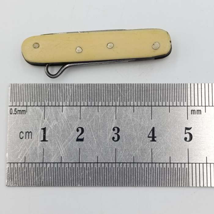Vintage miniature pocket knife with bootlace puller