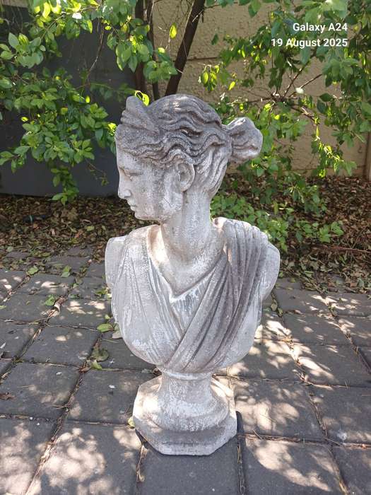 A concrete bust of a lady