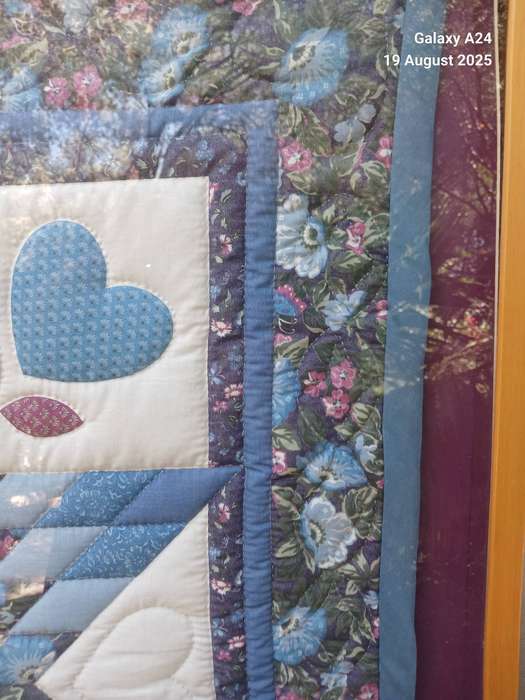 A large framed Amish quilt.