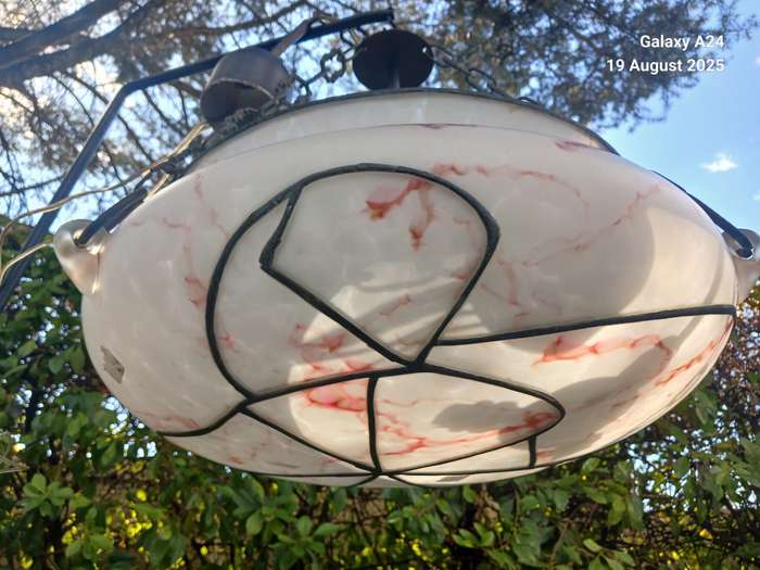 A hanging opaque glass marbled light