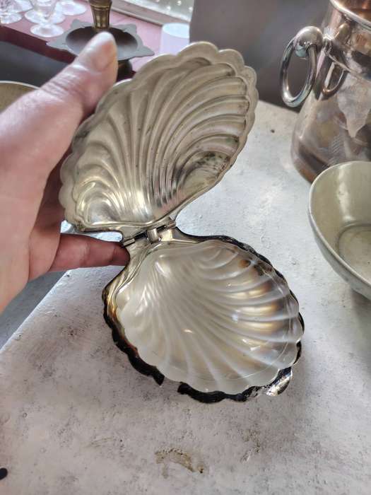 vintage silver-plated shell-shaped butter dish, often used for serving butter, caviar, or other cond