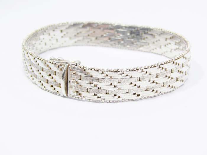 A Stunning Broad Articulated Woven Bracelet in Sterling Silver.