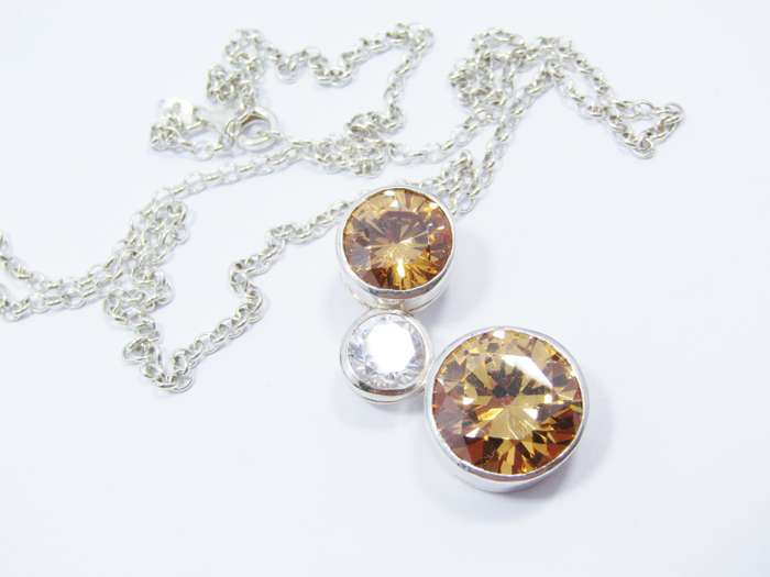 A Beautiful Orange And Clear Zirconia Pendant On Chain in Sterling Silver.