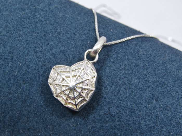 A Beautiful Spider Web Heart Locket Pendant on Chain in Sterling Silver.