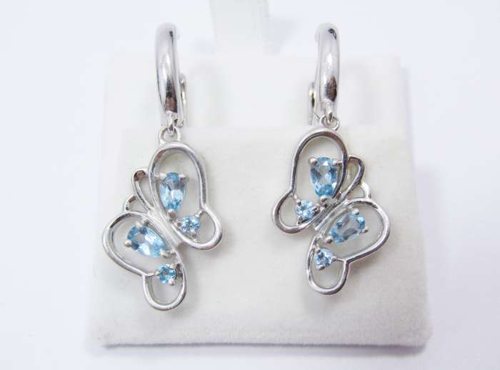 A Gorgeous Pair of Blue Topaz Butterfly Dangling earrings in Sterling Silver.
