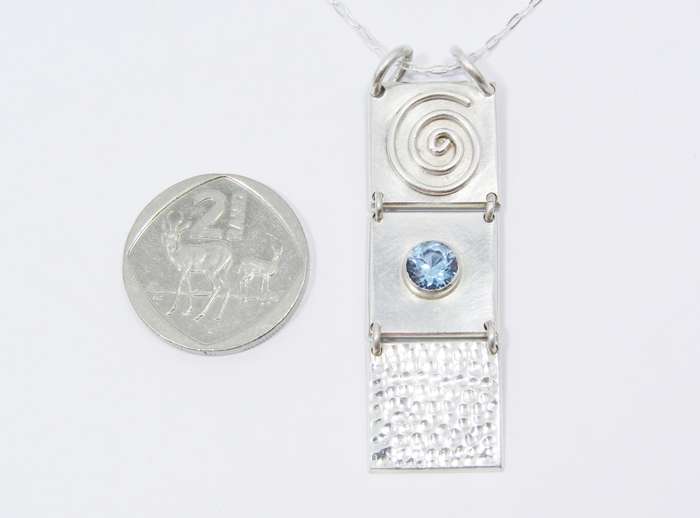 A Lovely 3 Paneled Blue Spinal Pendant on Chain in Sterling Silver.