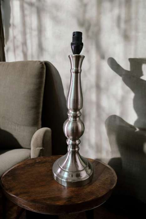 Add a touch of elegance to any space with this stunning Pillar Silver Metal Table Lamp.