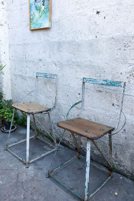 A pair of antique vintage Industrial worker chairs
