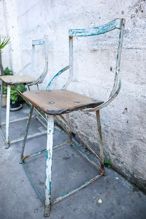 A pair of antique vintage Industrial worker chairs