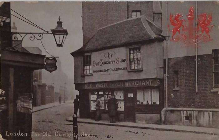RPPC of The Old Curiosity Shop embossed with city coat of arms in red