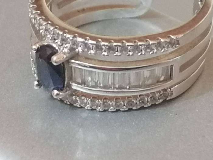 Beautiful open shank Sterling Silver 925. blue stone dress ring with CZ stones - Size M.