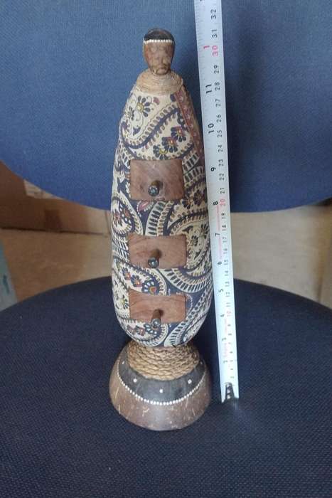 Vintage carved gourd with little trinket drawers on a Coconut shell stand. All natural