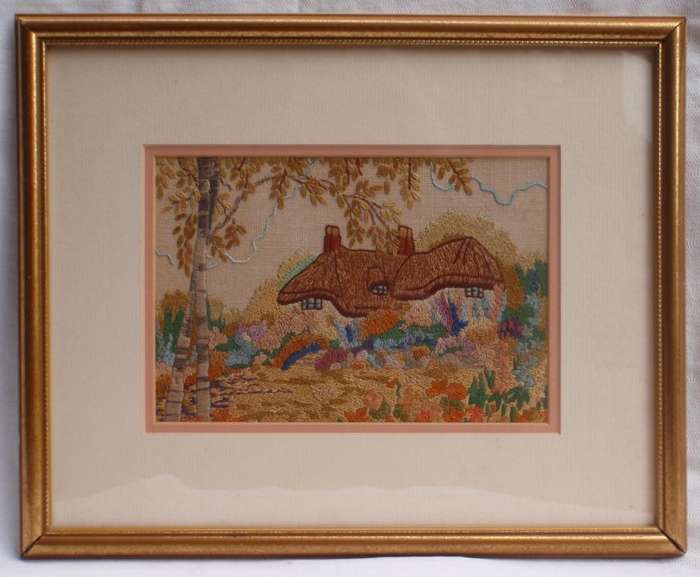 Vintage embroidery of a charming old world country cottage.
