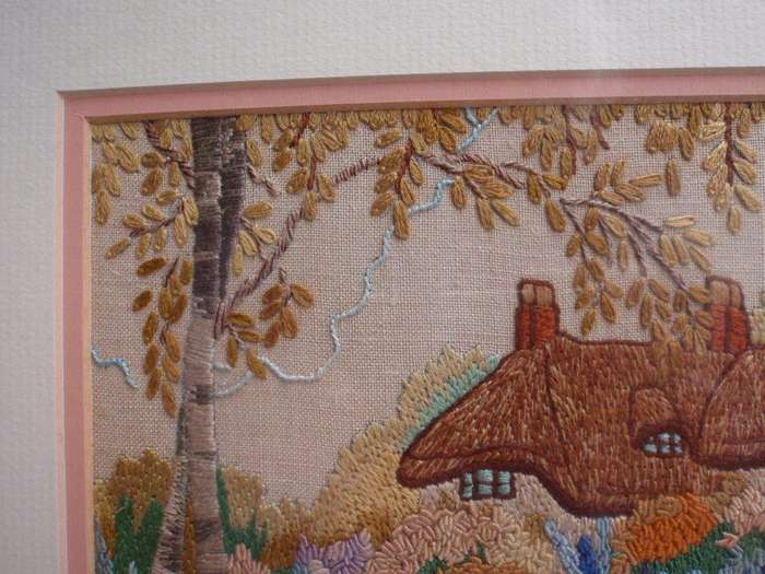 Vintage embroidery of a charming old world country cottage.