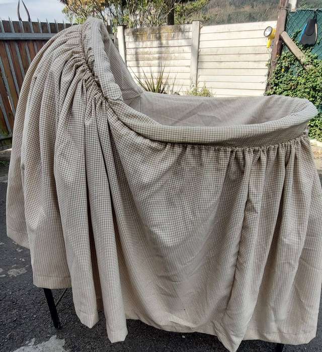 Rocking baby Moses/ wicker bassinet basket with a  fabric skirt.
