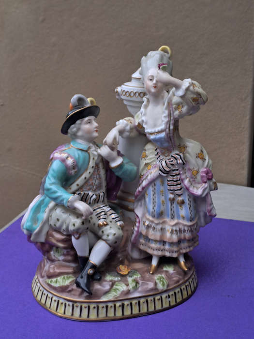 Porcelain stamped crown over M man courting lady
