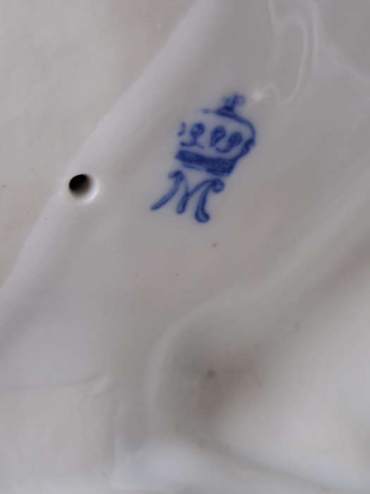Porcelain stamped crown over M man courting lady
