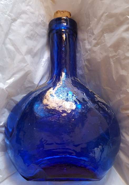 Small Blue Glass Bottle with Cork Stopper and Chip on Base