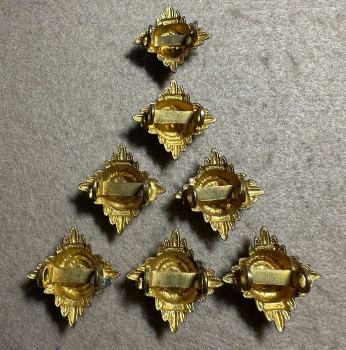 RHODESIA CROWNS AND PIPS - 7 BRASS PIPS WITH RED ENAMEL