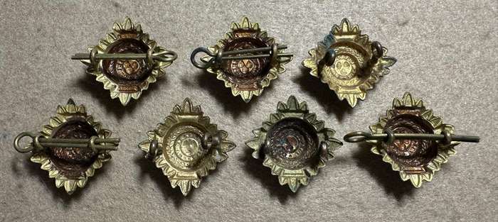 RHODESIA CROWNS AND PIPS - 7 BRASS PIPS WITH RED/GREEN ENAMEL