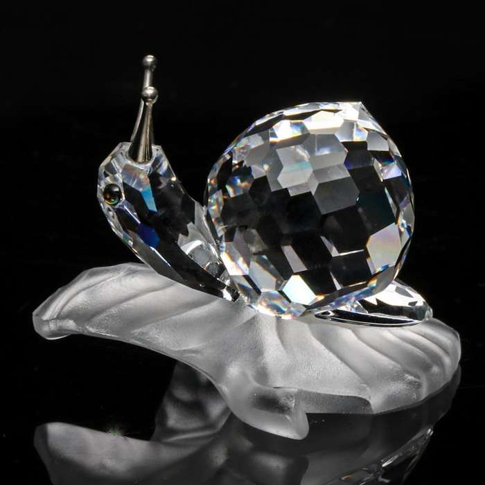 Swarovski Crystal Snail On A Vine Leaf Among Flowers and Foliage