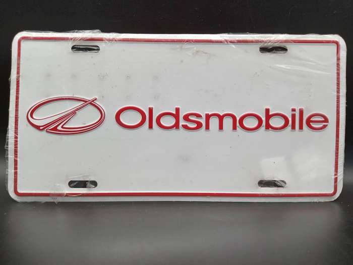 Vintage ! Oldsmobile - White Red Metal Embossed - Dealership License Plate