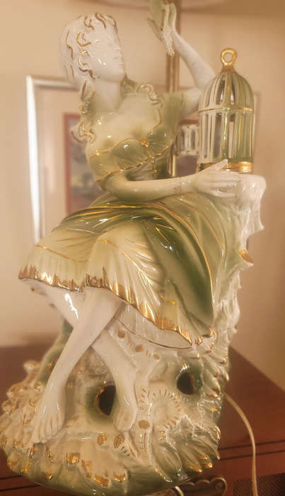 GILDED LADY WITH A BIRD FROM A CAGE, CERAMIC-FITTED TO BE A LAMP-FIGURINE 55CM HIGH