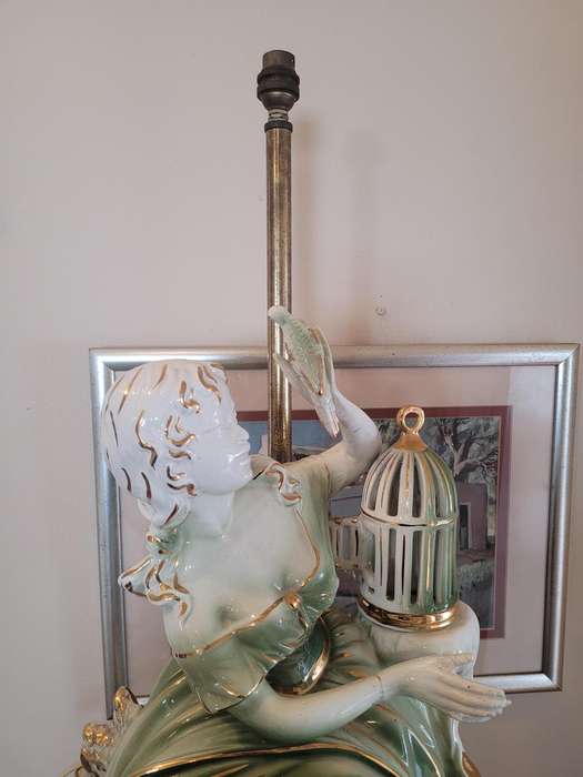 GILDED LADY WITH A BIRD FROM A CAGE, CERAMIC-FITTED TO BE A LAMP-FIGURINE 55CM HIGH